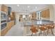 Spacious kitchen with granite countertops, stainless steel appliances, and barstool seating at the island at 7183 Majestic Bluff Pl, Las Vegas, NV 89113