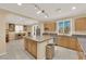 Bright kitchen with a large island, stainless steel appliances, granite countertops, and an adjacent dining area at 7183 Majestic Bluff Pl, Las Vegas, NV 89113