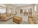Spacious living room with tan sofas, archways, and tile flooring throughout the open-concept floor plan at 7183 Majestic Bluff Pl, Las Vegas, NV 89113