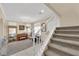 Inviting living room features a staircase, large windows, and a gorgeous chandelier at 7183 Majestic Bluff Pl, Las Vegas, NV 89113