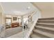 Cozy living room with carpet, piano, chandelier, and staircase at 7183 Majestic Bluff Pl, Las Vegas, NV 89113