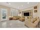 Cozy living room with neutral decor, tile flooring, and plantation shutters at 7183 Majestic Bluff Pl, Las Vegas, NV 89113