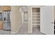 Bright, long hallway with a large pantry with adjustable shelving next to the modern kitchen at 7183 Majestic Bluff Pl, Las Vegas, NV 89113