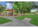 Community park featuring playground equipment and covered picnic areas surrounded by mature trees at 7183 Majestic Bluff Pl, Las Vegas, NV 89113