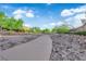Community walking path lined with desert landscaping and mature trees for scenic outdoor recreation at 7183 Majestic Bluff Pl, Las Vegas, NV 89113