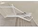 Carpeted staircase with white railing and natural light at 7183 Majestic Bluff Pl, Las Vegas, NV 89113