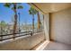 Balcony with railing featuring a view of tropical plants and trees at 7189 S Durango Dr # 208, Las Vegas, NV 89113