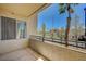 Balcony with railing featuring a view of tropical plants and trees at 7189 S Durango Dr # 208, Las Vegas, NV 89113