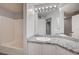 Bathroom features granite counters, white cabinets, a large mirror, and tub with shower at 7189 S Durango Dr # 208, Las Vegas, NV 89113