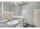 Bathroom features granite counters, white cabinets, a large mirror, and updated fixtures at 7189 S Durango Dr # 208, Las Vegas, NV 89113