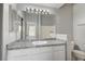 Bathroom with granite countertops, decorative lighting, and an expansive mirror at 7189 S Durango Dr # 208, Las Vegas, NV 89113