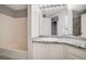 Bathroom featuring granite countertop vanity, white cabinets and tub with shower at 7189 S Durango Dr # 208, Las Vegas, NV 89113