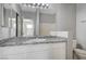 Bathroom featuring large granite vanity and white cabinets at 7189 S Durango Dr # 208, Las Vegas, NV 89113