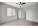 Bedroom with wood-style tile floors, large window, and an ensuite bathroom at 7189 S Durango Dr # 208, Las Vegas, NV 89113