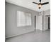 Bedroom with a modern ceiling fan, large window and two entry doors at 7189 S Durango Dr # 208, Las Vegas, NV 89113