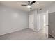 Bedroom with tile floor, ceiling fan and open doorway to bathroom at 7189 S Durango Dr # 208, Las Vegas, NV 89113