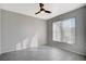 A bedroom featuring light gray walls, modern ceiling fan and tile floors at 7189 S Durango Dr # 208, Las Vegas, NV 89113