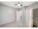 Bright bedroom featuring tile flooring, ceiling fan, walk-in closet, and en-suite bathroom at 7189 S Durango Dr # 208, Las Vegas, NV 89113