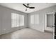 Bright bedroom featuring wood-style tile floors, a ceiling fan, and natural lighting at 7189 S Durango Dr # 208, Las Vegas, NV 89113