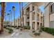 Beautiful multi-story condo building with manicured landscaping, and a walking path at 7189 S Durango Dr # 208, Las Vegas, NV 89113