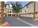 Exterior view of condo building with an ample parking and garage area at 7189 S Durango Dr # 208, Las Vegas, NV 89113