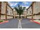 Exterior view of condo building with a well maintained parking area at 7189 S Durango Dr # 208, Las Vegas, NV 89113