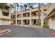 Exterior view of condo building with an ample parking and garage area at 7189 S Durango Dr # 208, Las Vegas, NV 89113