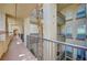 View of the exterior hallway featuring building architecture and a palm tree at 7189 S Durango Dr # 208, Las Vegas, NV 89113