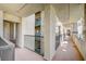 Hallway view featuring stucco walls, metal railings, and building architecture at 7189 S Durango Dr # 208, Las Vegas, NV 89113