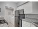 A modern kitchen featuring granite countertops, stainless steel appliances, and adjacent laundry room at 7189 S Durango Dr # 208, Las Vegas, NV 89113