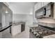 Modern kitchen featuring stainless steel appliances, granite countertops, and white cabinets at 7189 S Durango Dr # 208, Las Vegas, NV 89113
