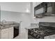 Modern kitchen with white cabinets, granite countertops, stainless steel sink and gas range at 7189 S Durango Dr # 208, Las Vegas, NV 89113