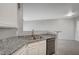 Bright kitchen with granite countertops, stainless steel appliances, and light grey flooring at 7189 S Durango Dr # 208, Las Vegas, NV 89113