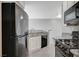Modern kitchen with granite countertops, stainless steel appliances, and white cabinets at 7189 S Durango Dr # 208, Las Vegas, NV 89113