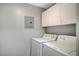 Laundry room with white washer and dryer and storage at 7189 S Durango Dr # 208, Las Vegas, NV 89113
