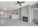 Bright living room featuring a fireplace, tile floors, view to kitchen, and updated lighting at 7189 S Durango Dr # 208, Las Vegas, NV 89113