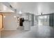 Bright open-concept living room with gray tiling, fireplace, modern kitchen, and sliding glass door to the balcony at 7189 S Durango Dr # 208, Las Vegas, NV 89113