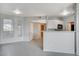 Bright living room featuring modern lighting, view to kitchen, and white trim at 7189 S Durango Dr # 208, Las Vegas, NV 89113