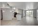 Spacious living room with tile floors, modern lighting, and a sliding glass door to the outdoor patio at 7189 S Durango Dr # 208, Las Vegas, NV 89113