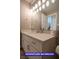 Bright bathroom featuring a marble countertop, sleek fixtures, and modern vanity at 7365 Mission Hills Dr, Las Vegas, NV 89113