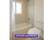 Upstairs bathroom featuring a shower and tub with tile surround at 7365 Mission Hills Dr, Las Vegas, NV 89113