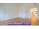 Large primary bedroom with wood-look flooring, and attached bathroom at 7365 Mission Hills Dr, Las Vegas, NV 89113