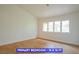 Primary bedroom with natural light and wood-look flooring at 7365 Mission Hills Dr, Las Vegas, NV 89113