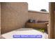 Private courtyard with tan stucco wall offering a secluded outdoor space at 7365 Mission Hills Dr, Las Vegas, NV 89113