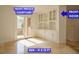 Den featuring built-in cabinets, a view of the courtyard, and a front door at 7365 Mission Hills Dr, Las Vegas, NV 89113