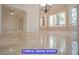 Formal dining room boasting large windows, tile flooring and a grand chandelier at 7365 Mission Hills Dr, Las Vegas, NV 89113