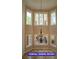 Dining area with a chandelier, and natural light from the tall surrounding windows at 7365 Mission Hills Dr, Las Vegas, NV 89113
