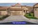 Charming home exterior with a two-car garage, well-maintained landscaping, and a tile roof, enhancing its curb appeal at 7365 Mission Hills Dr, Las Vegas, NV 89113