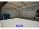 Clean two car garage with sealed concrete floors and overhead storage at 7365 Mission Hills Dr, Las Vegas, NV 89113