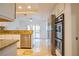 Open kitchen view with granite countertops, stainless steel appliances, and patio access at 7365 Mission Hills Dr, Las Vegas, NV 89113